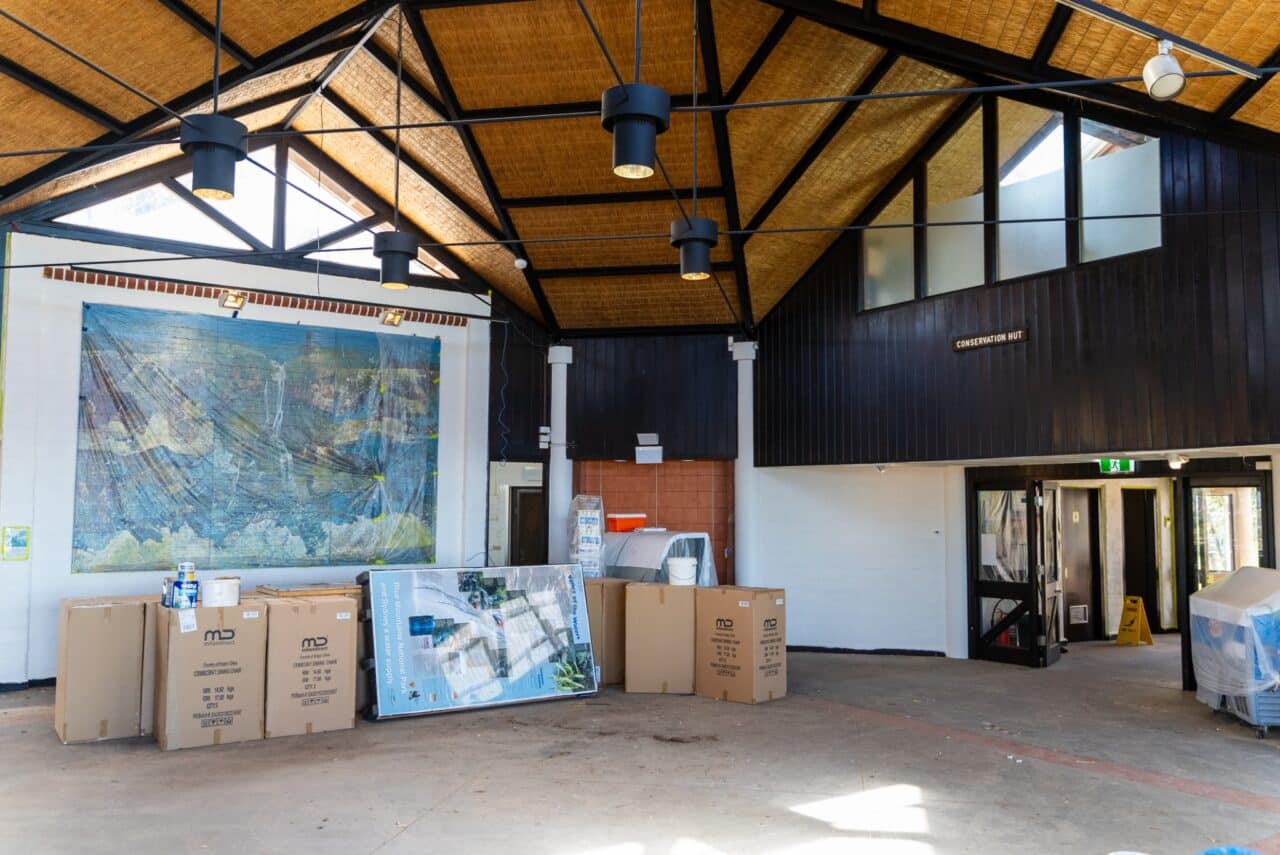 Interior of a hut with high ceilings exposing structural beams